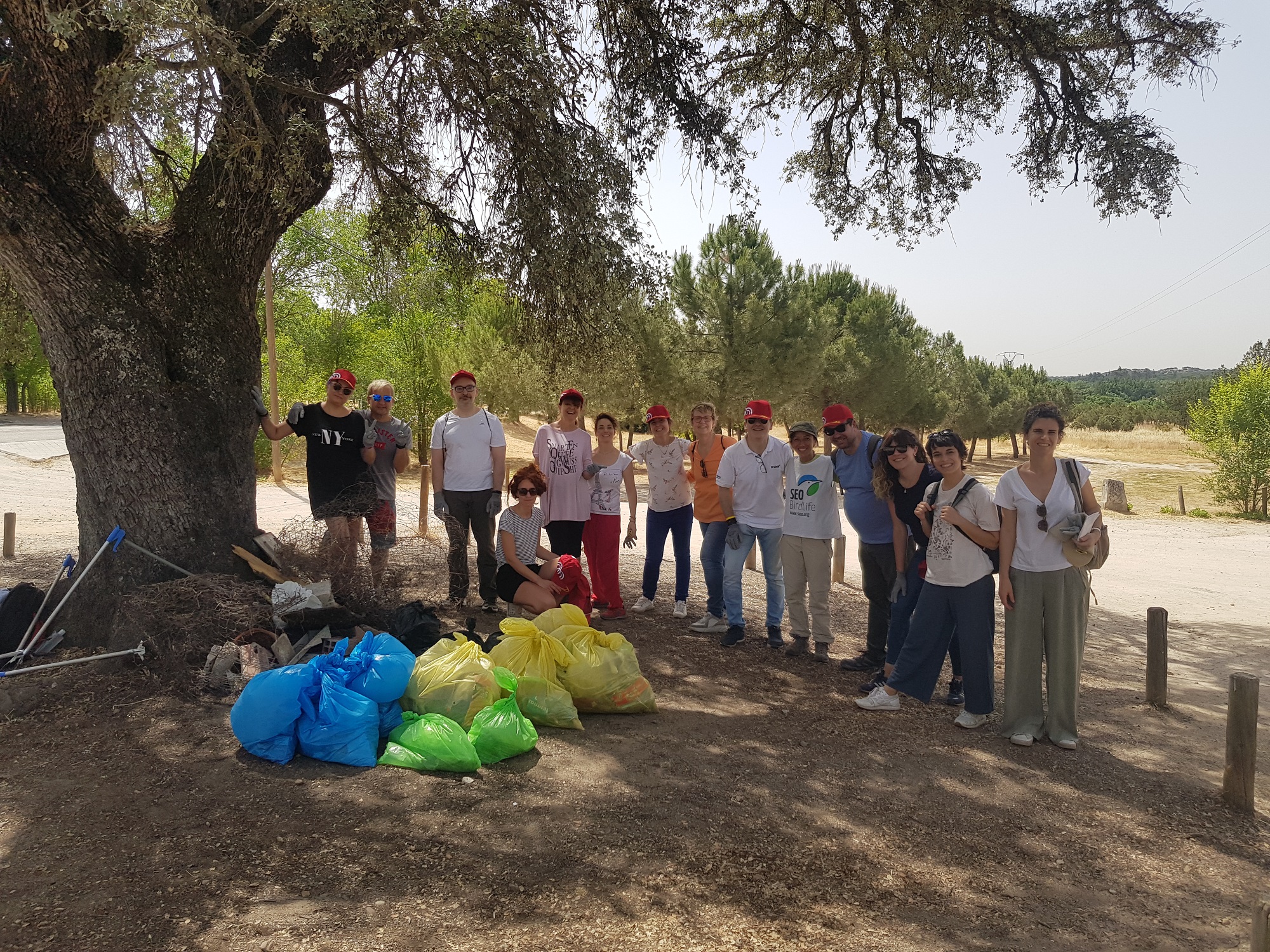 Foto en la que se ve al grupo de participantes con bolsas llenas de basura
