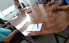 Imagen de uno de los talleres de Cristina en el que aparecen las manos de varias personas alrededor de una mesa redonda