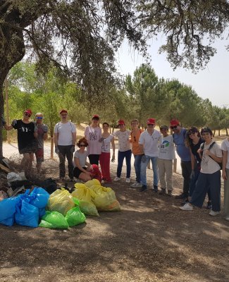 Foto en la que se ve al grupo de participantes con bolsas llenas de basura